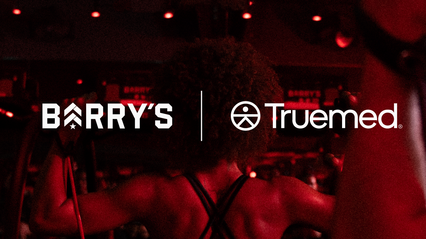 BARRY'S X TRUMED LOGOS OVER IMAGE OF MODEL DOING A BACK WORKOUT WITH BANDS